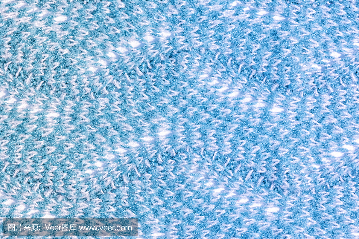 羊毛产品的质地特写。针织锯齿形模式。空白蓝色背景布局。